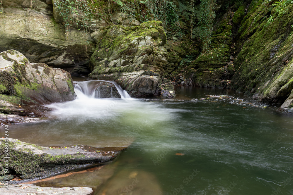 Long exposure of a waterfall on the East Lyn River at Watersmeet in Exmoor National Park Long exposure of a waterfall on the East Lyn River at Watersmeet in Exmoor National Park