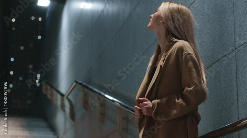 beautiful young girl blonde walks around the night city