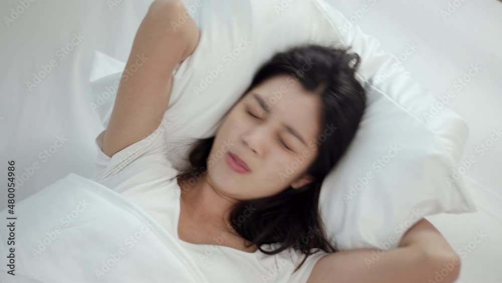 Beautiful woman can't fall asleep, moving restless on bed. Young woman having bad dream, sleep troubles trying can not sleep because of loud noise from outside. Beautiful woman can't fall asleep, moving restless on bed. Young woman having bad dream, sleep troubles trying can not sleep because of loud noise from outside.