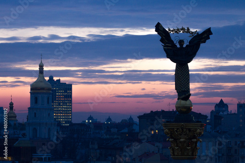 Independence Monument, Majdan Nesaleschnosti, Kyiv, Ukraine, Statue of Berehynia at evening dusk sunset photo