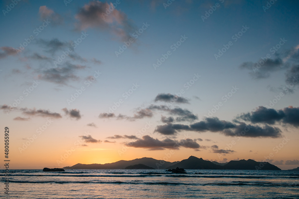 Calm sea with sunset sky and sun through the clouds over. Meditation ocean and sky background. Tranquil seascape. Horizon over the water.