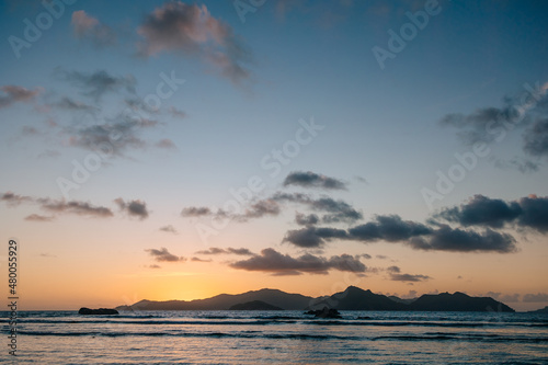 Calm sea with sunset sky and sun through the clouds over. Meditation ocean and sky background. Tranquil seascape. Horizon over the water.