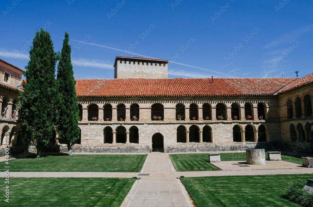 Front view of the courtyard of the Santo Domingo convent in Caleruega with two large cypress trees, Burgos, Castilla y León, Spain.