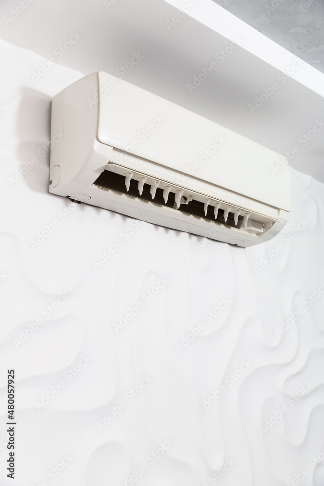 White air conditioner in the living room on the white wall White air conditioner in the living room on the white wall