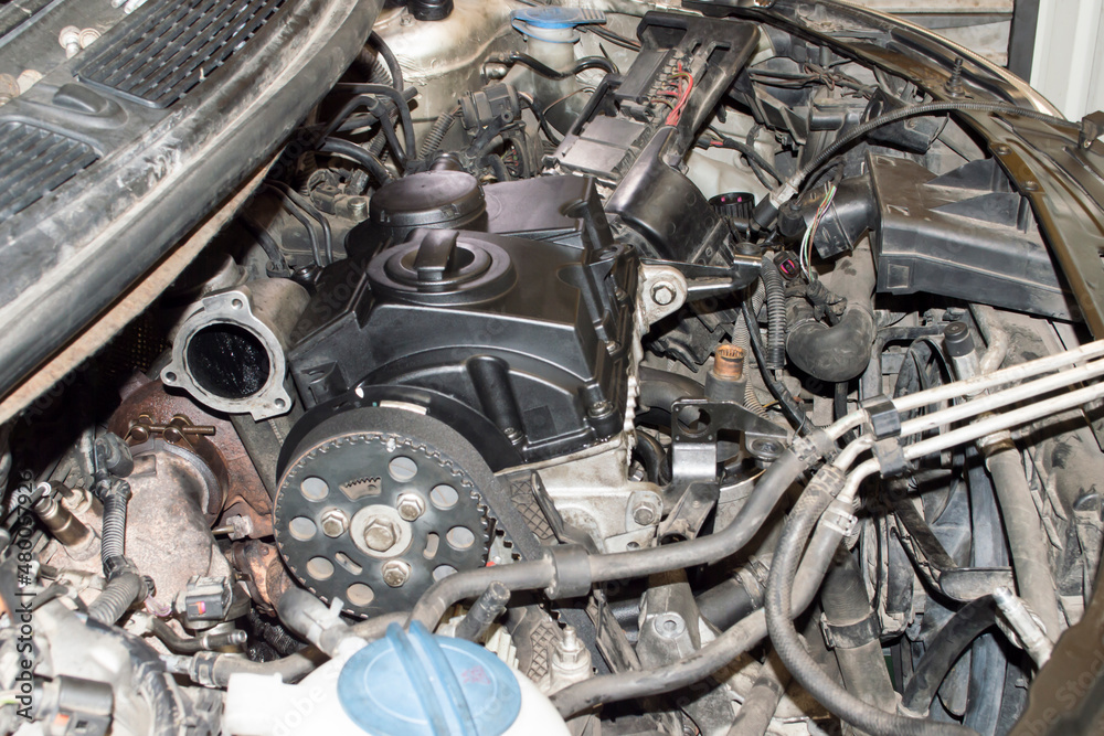 View from the camshaft drive side of the three-cylinder diesel engine mounted under the hood of the car View from the camshaft drive side of the three-cylinder diesel engine mounted under the hood of the car