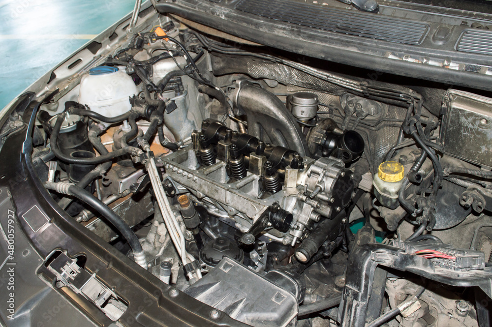 Threecylinder engine with the valve cover removed under the hood of