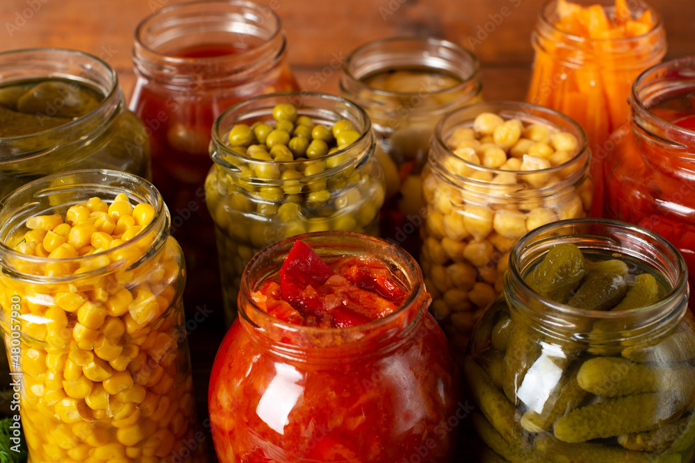 canned vegetables on a wooden table canned vegetables on a wooden table