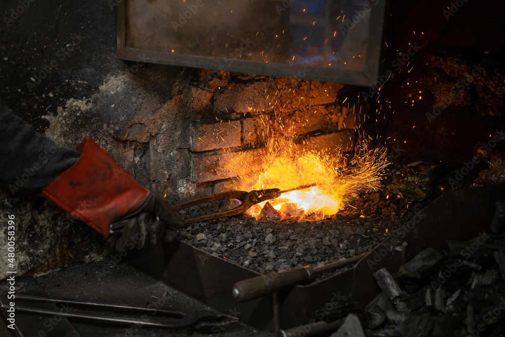 blacksmith warming blank metal on coal fire blacksmith warming blank metal on coal fire