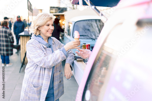 Super happiness girl holding ice cream in the right hand. High quality photo