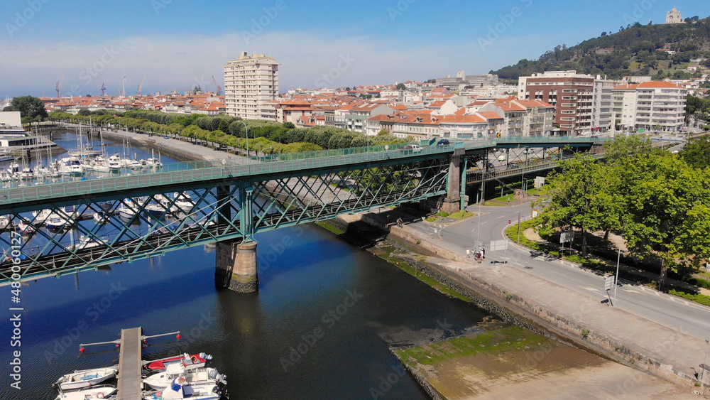 Naklejka premium The Gustave Eiffel Bridge over the river Lima in Viana do Castelo. Aerial panoramic cityscape view of Viana and the Marina.