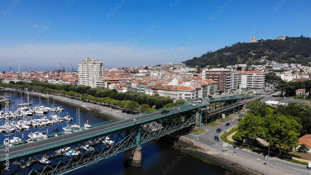 Viana do Castelo, Portugal, June 10, 2021: The Gustave Eiffel Bridge over the river Lima in Viana do Castelo. Aerial panoramic cityscape view of Viana and the Marina.