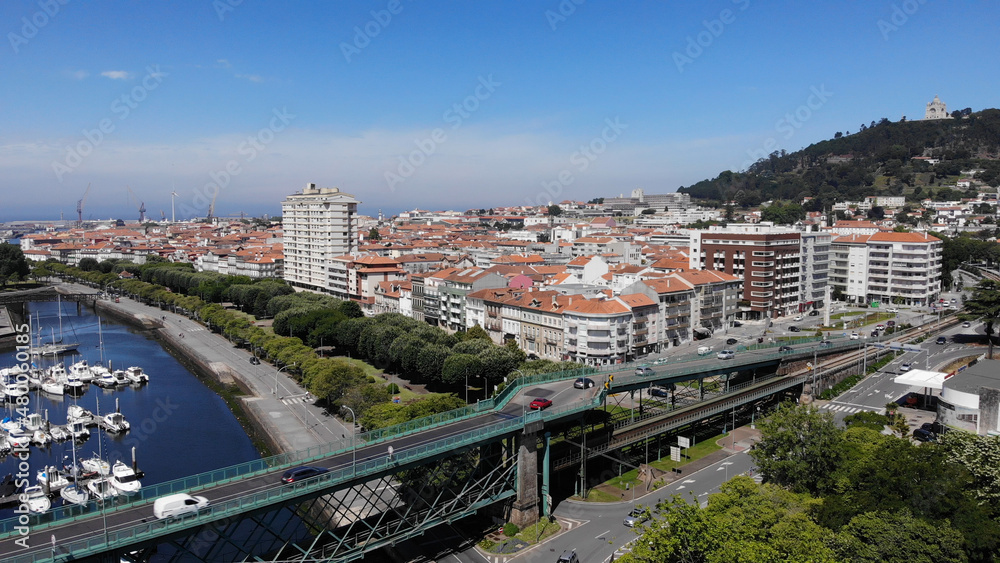Fototapeta premium Aerial view of a bridge over the river Lima, linking the parish of Santa Maria Maggiore, in Viana do Castelo, Darque. Was opened in 1878, having been designed by the architect Gustave Eiffel.