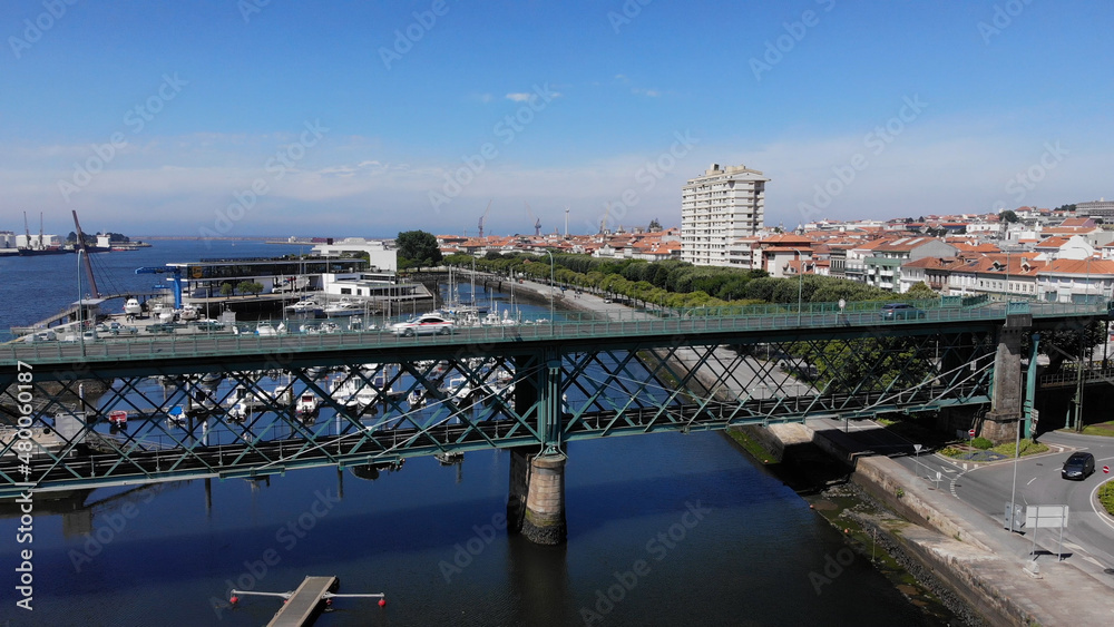 Viana do Castelo, Portugal, June 10, 2021: The Gustave Eiffel Bridge over the river Lima in Viana do Castelo. Aerial panoramic cityscape view of Viana and the Marina.