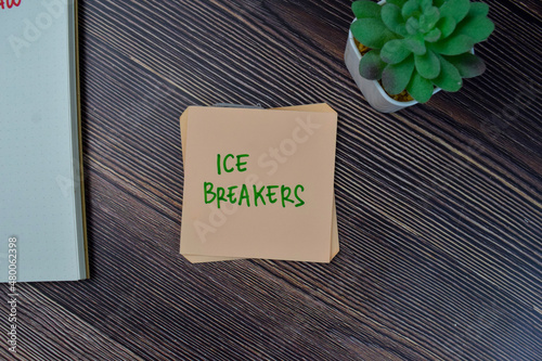фотографія Ice Breakers write on sticky notes isolated on Wooden Table.