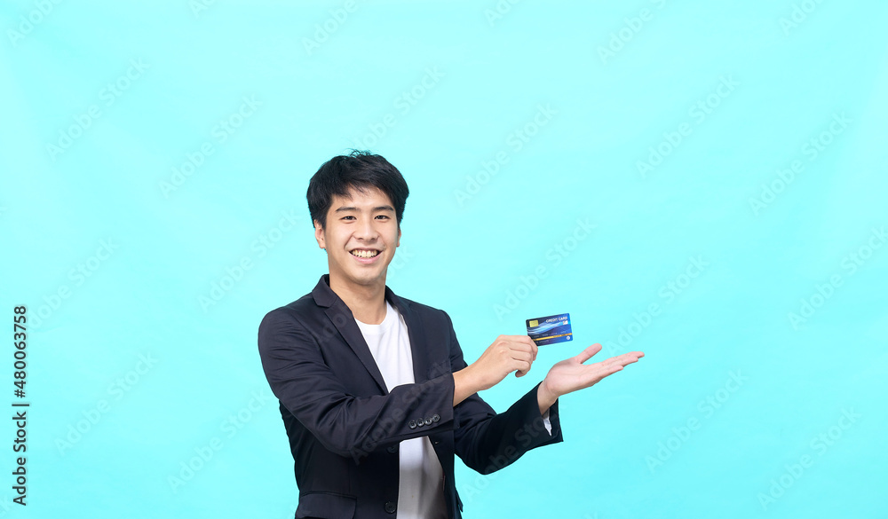Asian business man credit card on blue background Asian business man credit card on blue background