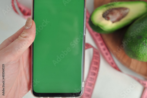 Smartphone with green screen and fresh vegetables copy space photo