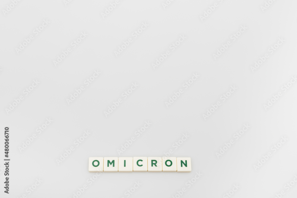 Fototapeta premium top view of white cubes with omicron lettering on grey background with copy space.