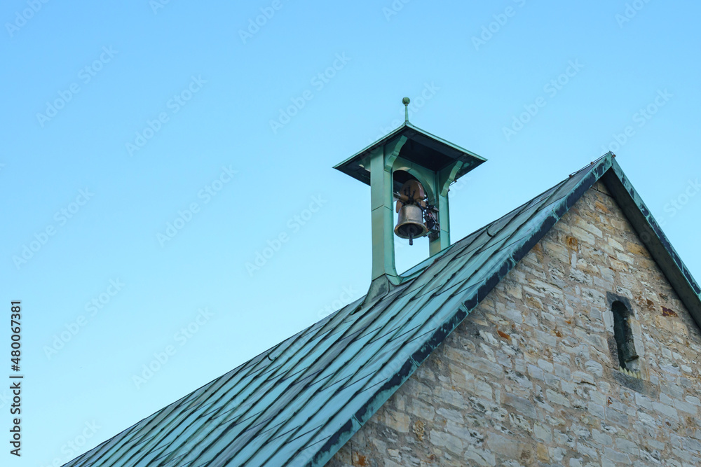 Bell on the roof of a church building. Against the blue sky. Bell on the roof of a church building. Against the blue sky.