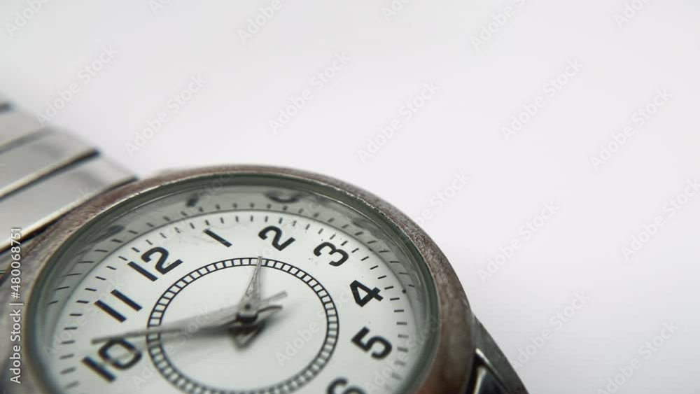 Macro view of wristwatch. Close-up of a worn watch full of scratches on a white background.
Macro view of wristwatch. Close-up of a worn watch full of scratches on a white background.