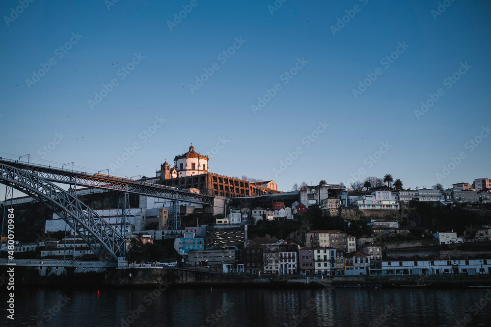 Fototapeta premium Top view of the Dom Luis I Bridge across the Douro River and Vila Nova de Gaia banks, Portugal.