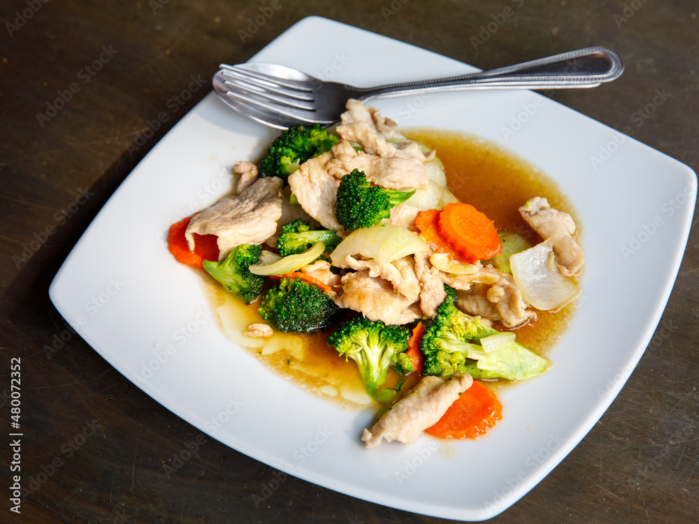 Broccoli stir fried with pork in oyster sauce, thai healthy food. Close up, selective focus