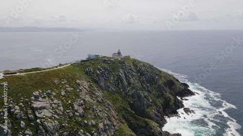 Aerial view of Cabo Finisterre, Galicia, Spain. Lighthouse on a mountain by sea with rock cliff. photo