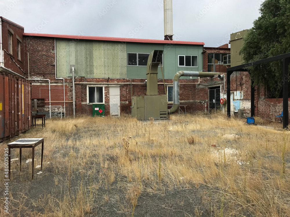 View of yard of an abandoned industrial warehouse site