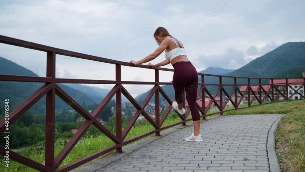 Woman stretching legs and enjoying nature scene Woman stretching legs and enjoying nature scene