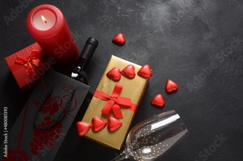 Love concept for Valentines day with sweet and romantic moment. The red Heart shapes sweets on dark background