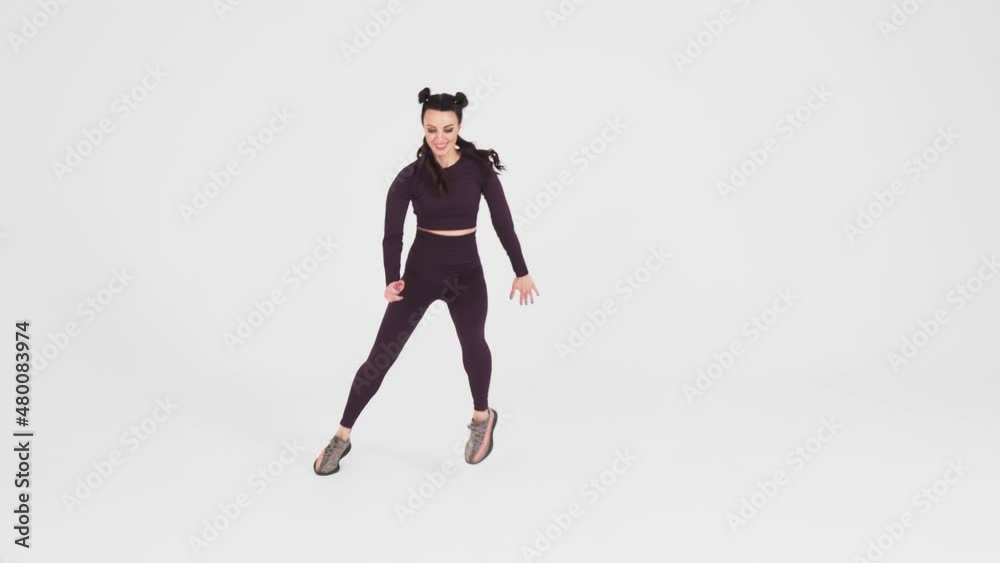Sporty woman exercising on white isolated background, doing exercises, jumping to maintain body shape, isolated on white background. Slow motion.
Sporty woman exercising on white isolated background, doing exercises, jumping to maintain body shape, isolated on white background. Slow motion.