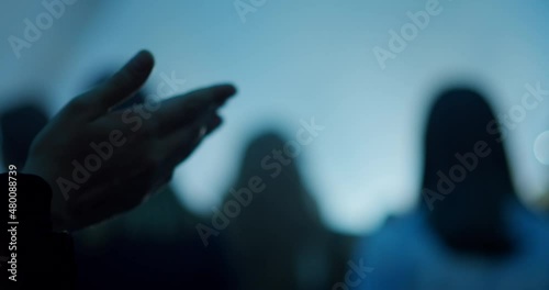 Christian Person Prays at Worship and Praise Night. Religious Music Event with Crowds of People, Concert Stage and Lights. 4K background handheld shot in slow motion photo