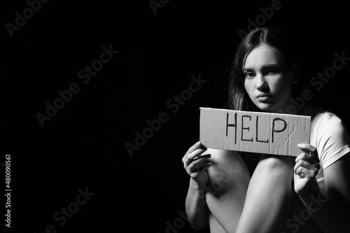Scared woman holding paper ...