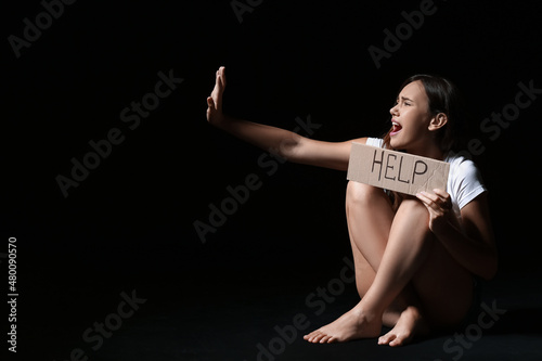 Scared woman holding paper ...