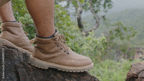 Shoes of traveler getting ready for hiking.