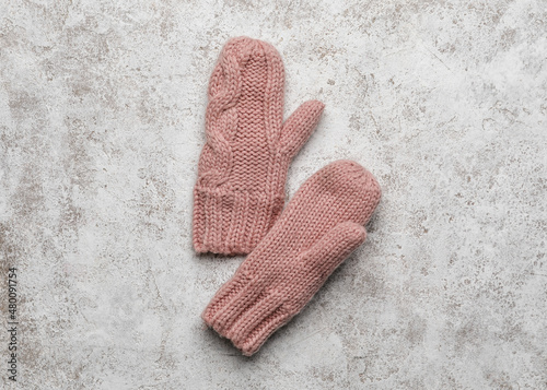 Pair of warm mittens on light background