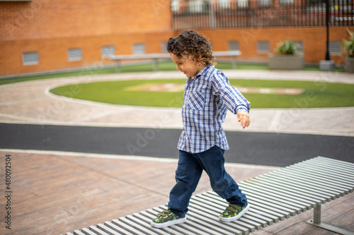 Cute little boy playing happily in the park