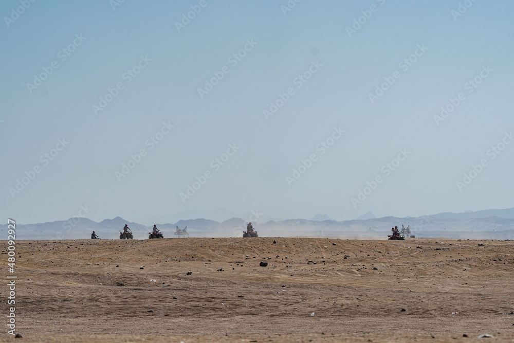People driving quad bikes during safari trip in Arabian desert not far from Hurghada city, Egypt