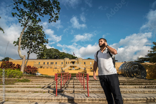 Картината върху платно adult tourist talking on the phone in a public park in the center of the city of