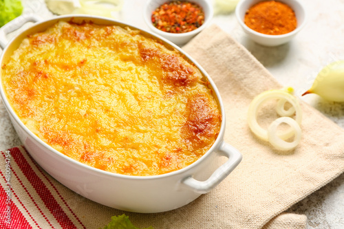 Baking dish with tasty English fish pie on table