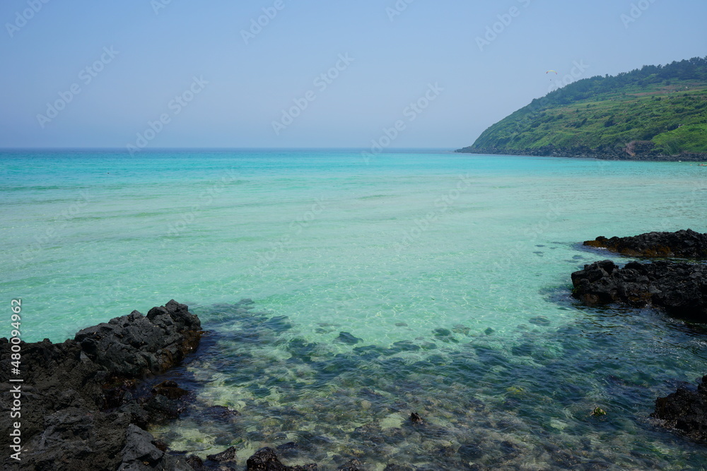 a shoaling beach with crystal-clear water