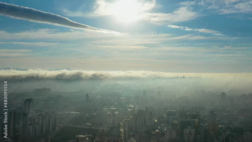 Panorama aerial view of fog morning landscape at dowtown Sao Paulo Brazil. Foggy morning and rays of sun above the clouds. Sunlight weather. Sunrise at city.