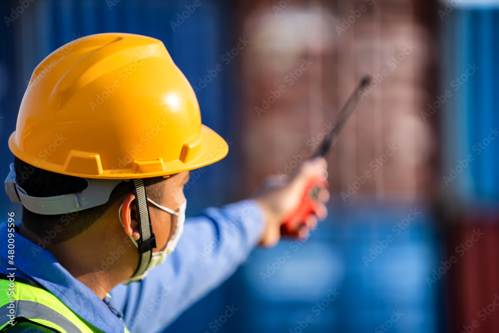 Industrial workers holding walkie talkies to coordinate. Industrial workers holding walkie talkies to coordinate.