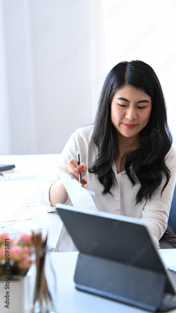 Young business woman explaining business information to her colleague. Young business woman explaining business information to her colleague.