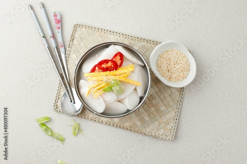 Traditional Korean food Tteokguk (Rice cake soup) with spoons and chopsticks, South Korea