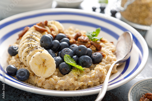Oatmeal with fresh blueberries and pecans and banana