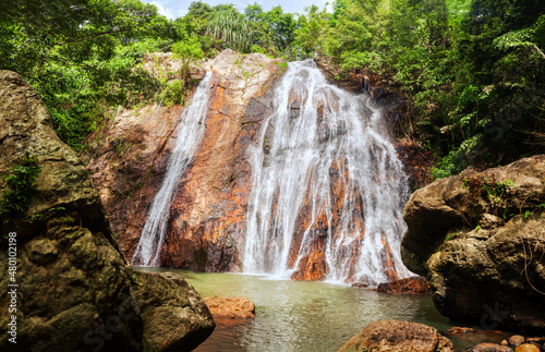 Fototapeta Naklejka Na Ścianę i Meble -  Na Muang Waterfall Koh Samui Island Thailand, Namuang Waterfall, falling water stream, mountain rocks landscape, tropical jungle forest, summer sunny day, tourism, travel, vacation, tourist attraction