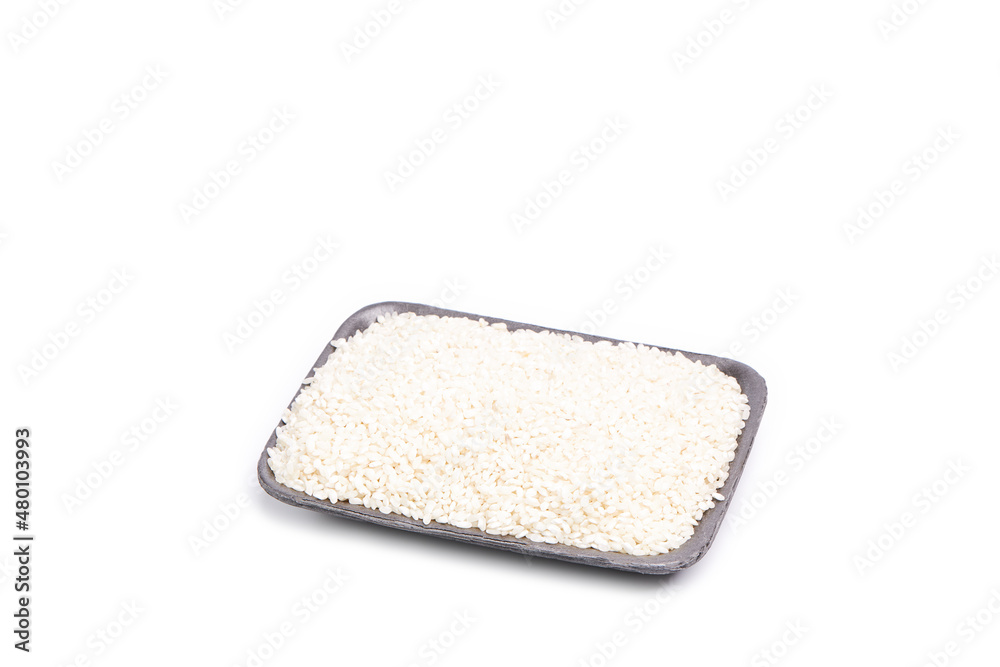 White rice grains on a tray on a white background. Oriental food White rice grains on a tray on a white background. Oriental food