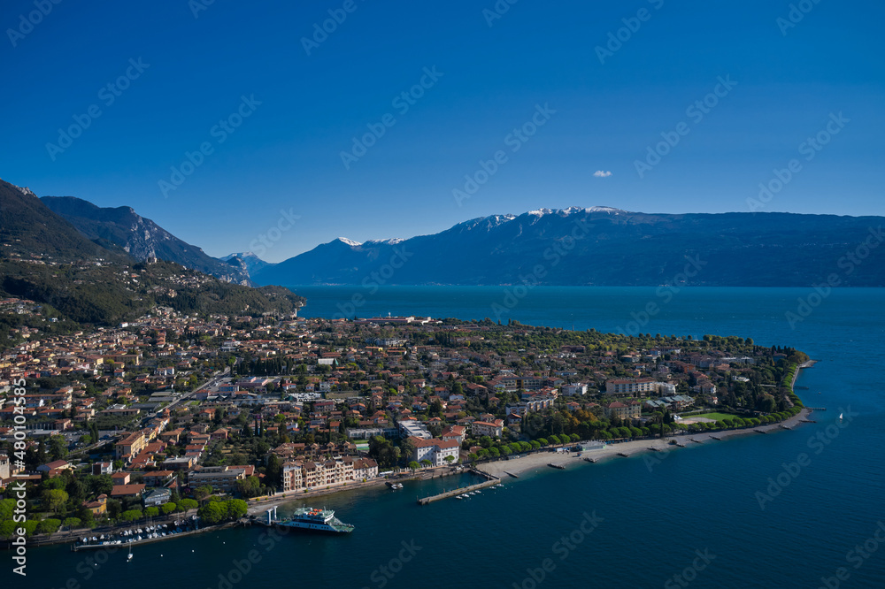 Aerial view of the town on Lake Garda. Panoramic view of the historic city of Toscolano Maderno on Lake Garda Italy. Tourist place on Lake Garda in the background Alps and blue sky.