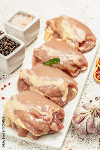 Raw chicken thigh without bones or skin. A useful ingredient for preparing healthy food, spices
