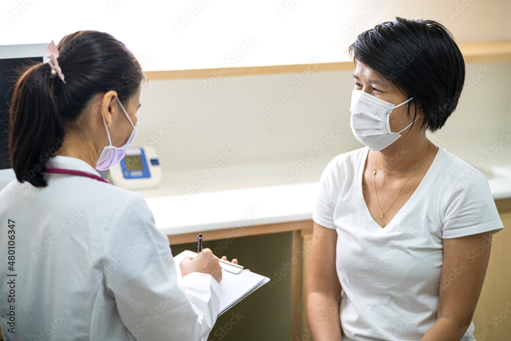 Fototapeta premium Female doctor talking with Asian female patient for physical checkup in hospital. Coronavirus, covid-19, medical and healthcare concept